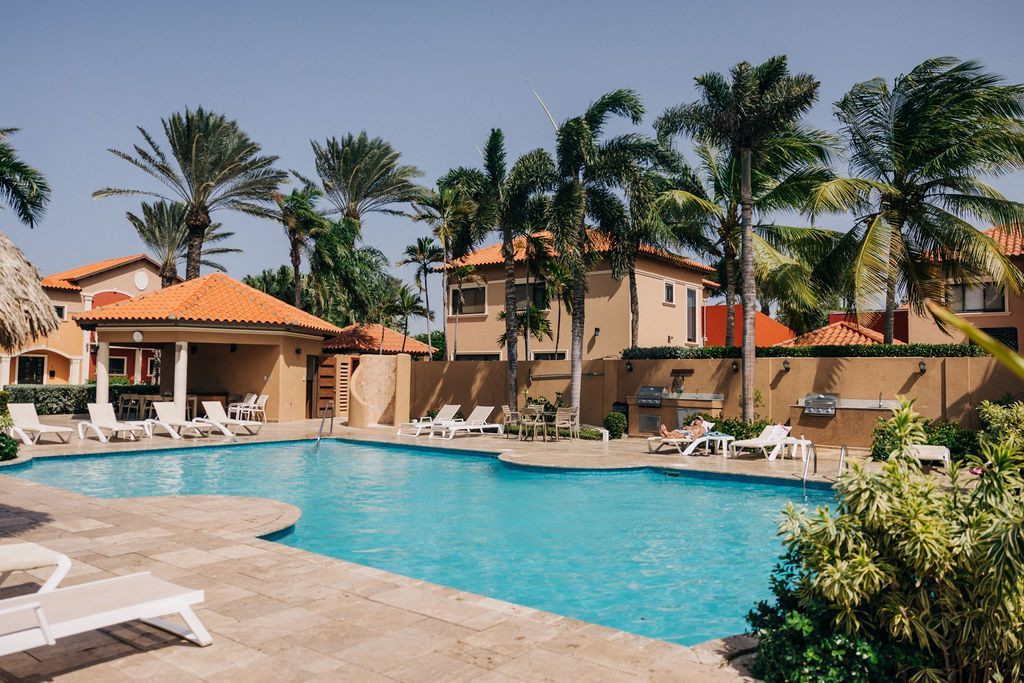Landscaped resort pool surrounded by palms